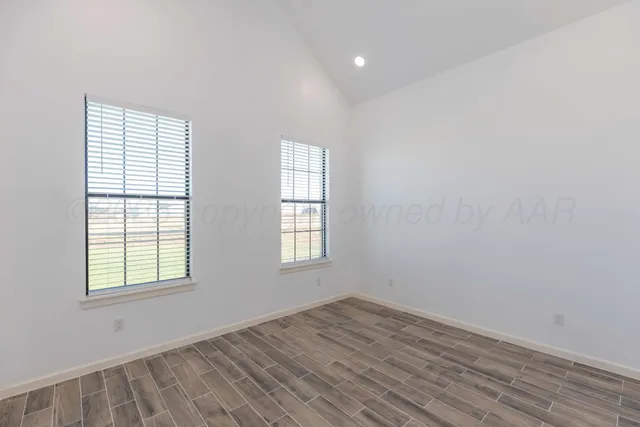 a view of a room with wooden floor and white walls