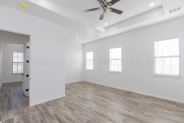a bathroom with a granite countertop sink a large mirror a window and a bathtub