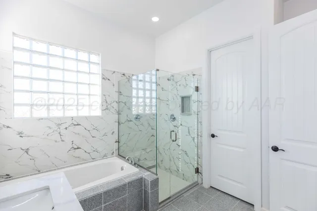 an empty room with wooden floor chandelier fan and windows