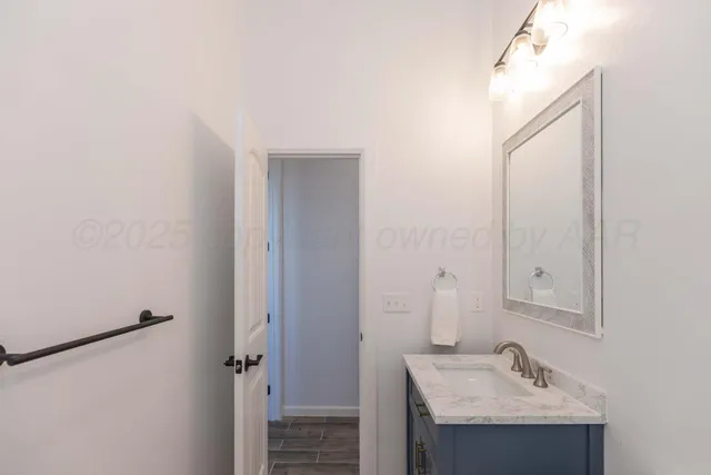a view of a kitchen with white cabinets