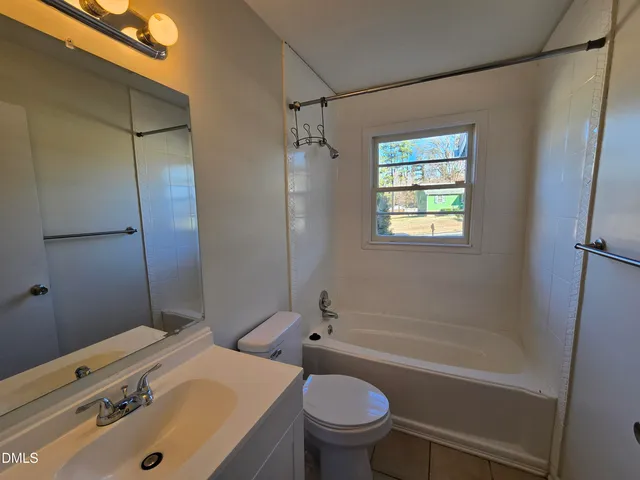 a view of a room with wooden floor and white walls
