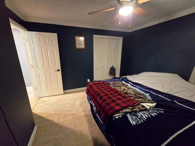 a bedroom with a bed and a mirror