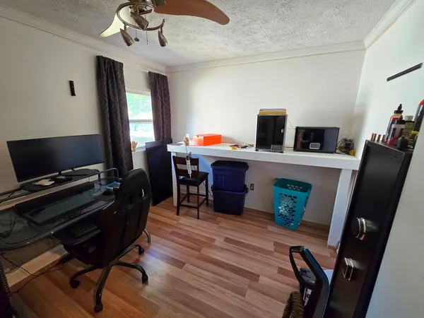 a work room with furniture and wooden floor
