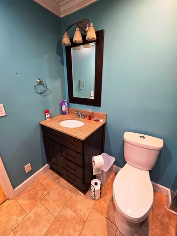 a room with a toilet sink and mirror