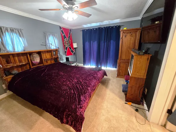 a bed sitting in a bedroom next to a window
