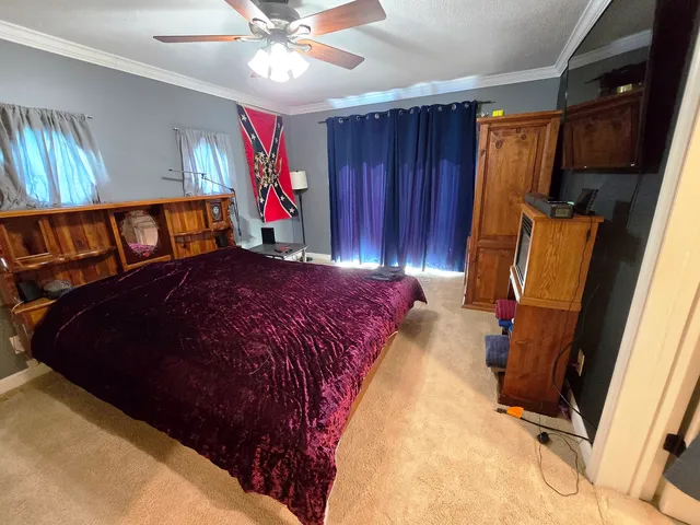 a bed sitting in a bedroom next to a window