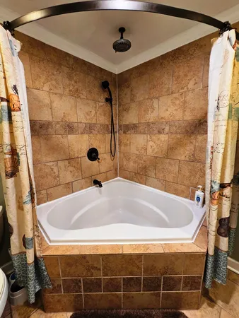 a bathroom with a tub and shower