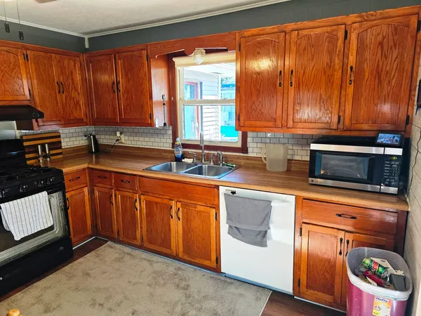 a kitchen with stainless steel appliances granite countertop a sink stove and cabinets