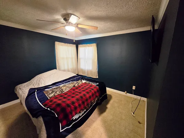 a bedroom with a bed and window