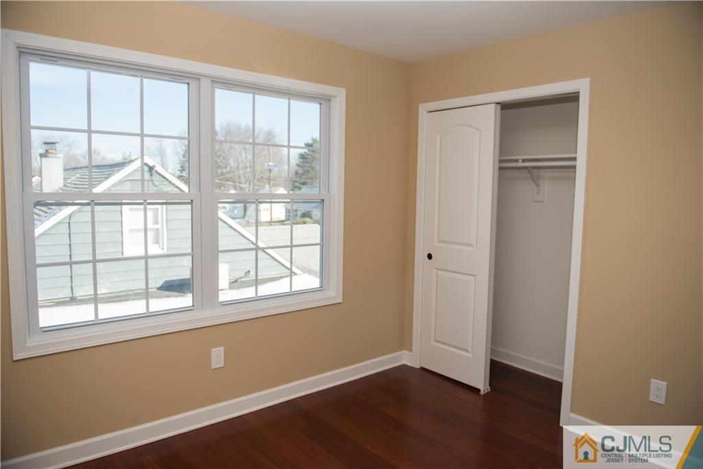 18 Richmond Road Edison, NJ 08817 - Photo 14 of 25 an empty room with wooden floor and windows