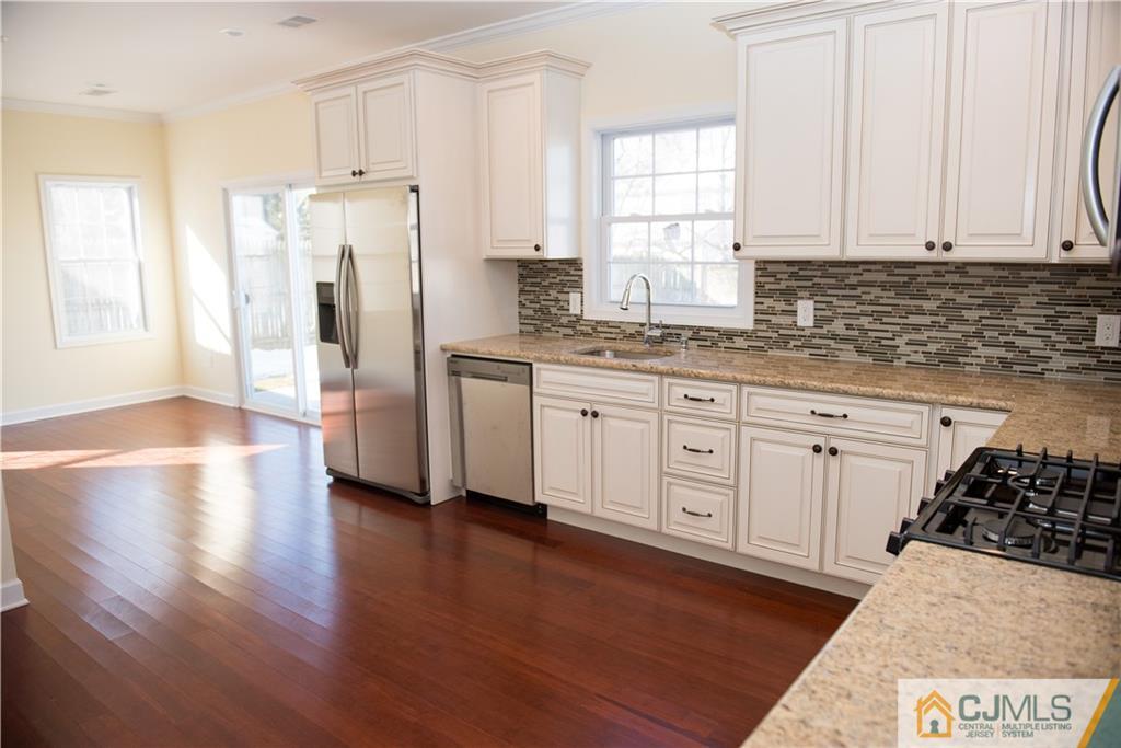 18 Richmond Road Edison, NJ 08817 - Photo 8 of 25 a kitchen with stainless steel appliances a refrigerator sink and cabinets