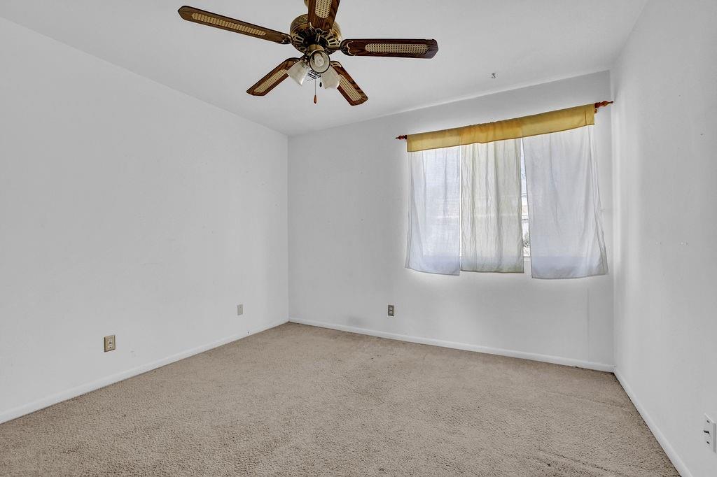 3312 Northcrest Road, Unit C Atlanta, GA 30340 - Photo 17 of 29 an empty room with chandelier fan