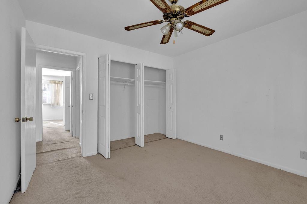 3312 Northcrest Road, Unit C Atlanta, GA 30340 - Photo 18 of 29 an empty room with closet and a chandelier fan