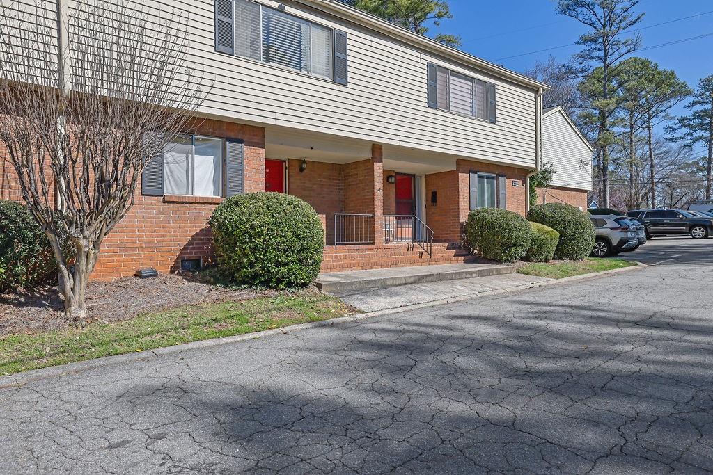3312 Northcrest Road, Unit C Atlanta, GA 30340 - Photo 2 of 29 a front view of a house with a yard