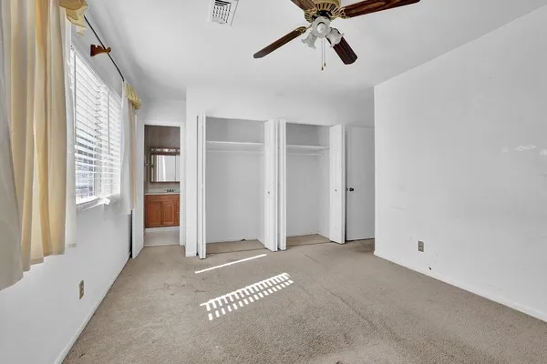 a view of a livingroom with a empty space and windows