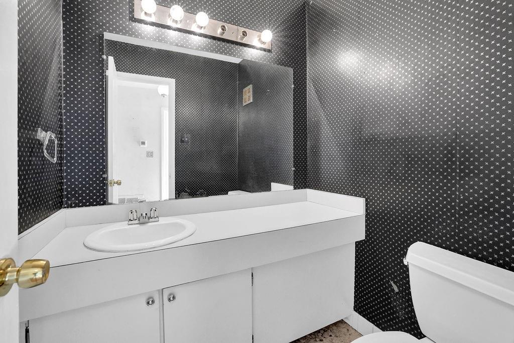 3312 Northcrest Road, Unit C Atlanta, GA 30340 - Photo 22 of 29 a bathroom with a sink a toilet and mirror