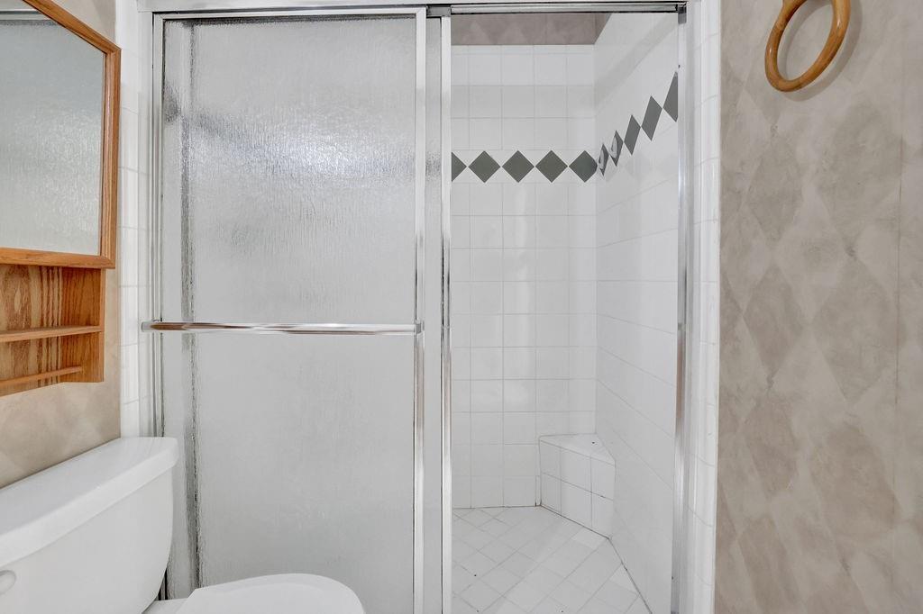 3312 Northcrest Road, Unit C Atlanta, GA 30340 - Photo 25 of 29 a bathroom with a granite countertop shower and a toilet