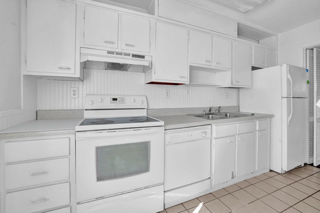 3312 Northcrest Road, Unit C Atlanta, GA 30340 - Photo 10 of 29 a kitchen with white cabinets and white appliances