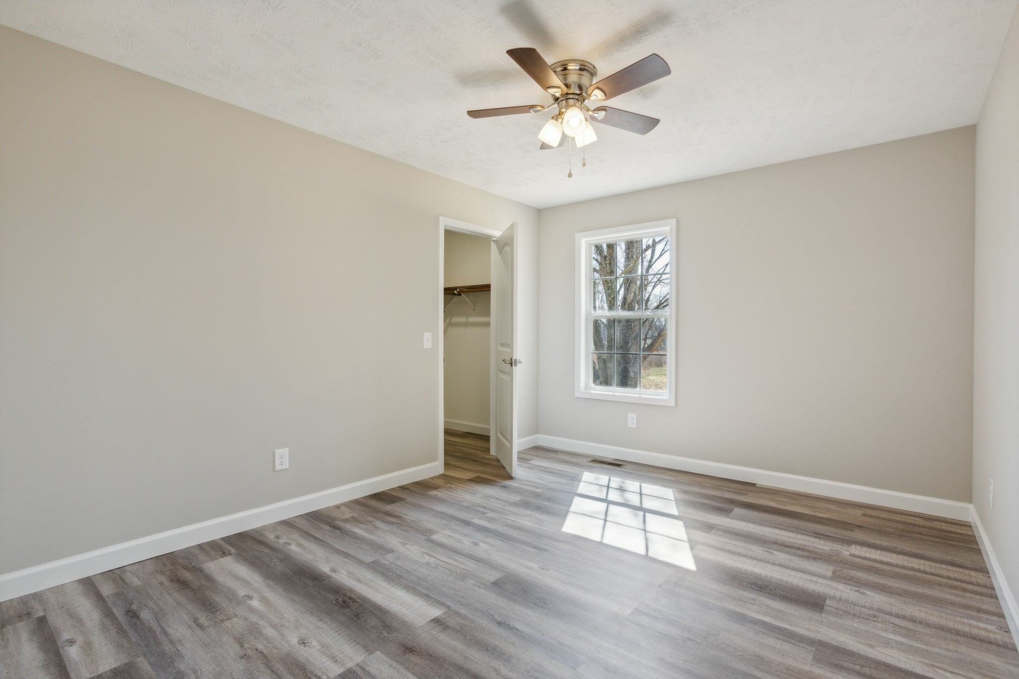 812 Days Road Lafayette, TN 37083 - Photo 20 of 25 a view of an empty room with a window and wooden floor