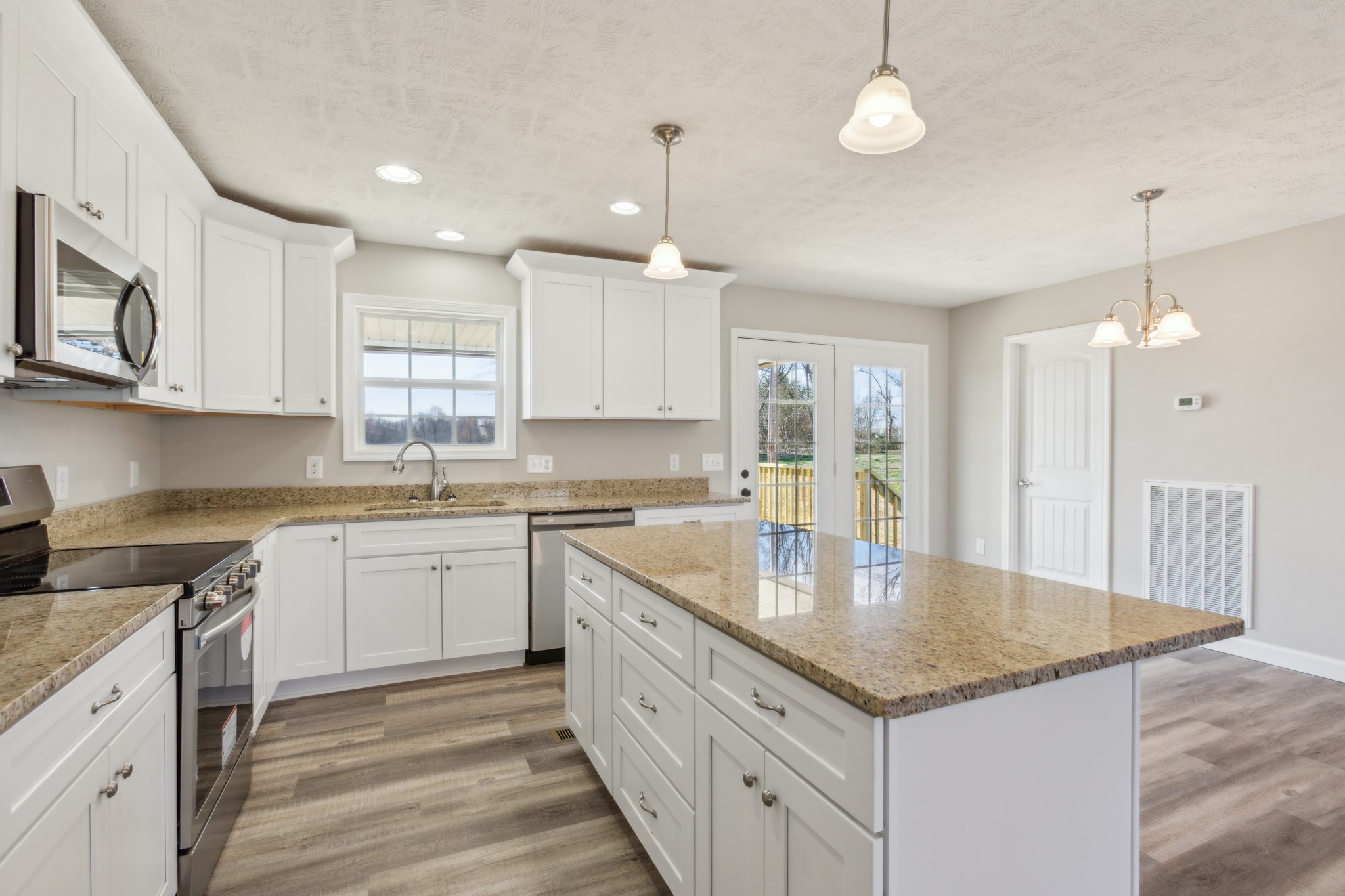 812 Days Road Lafayette, TN 37083 - Photo 7 of 25 a kitchen with granite countertop stainless steel appliances a sink stove and cabinets