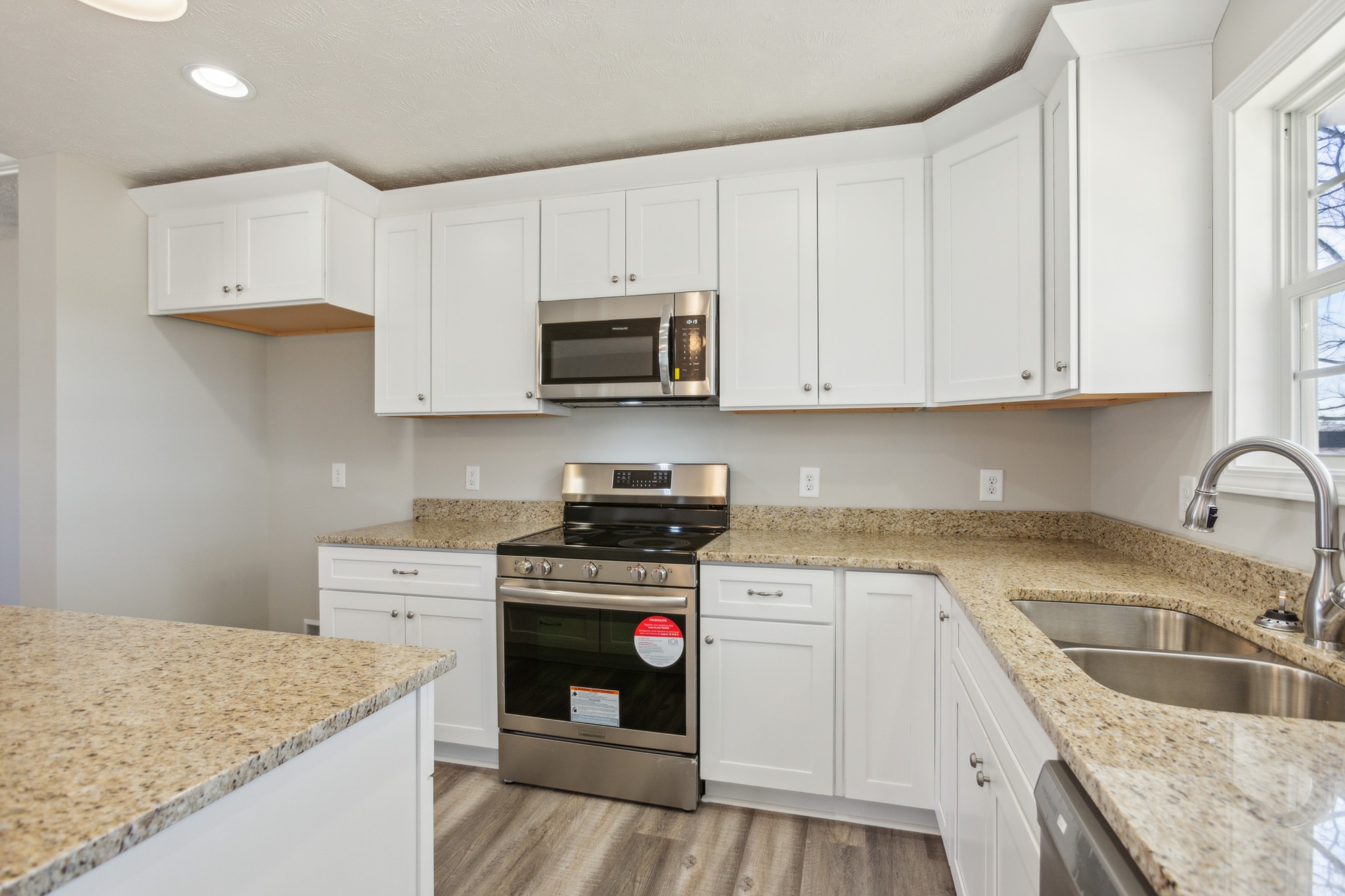 812 Days Road Lafayette, TN 37083 - Photo 8 of 25 a kitchen with cabinets appliances a sink and a counter top space