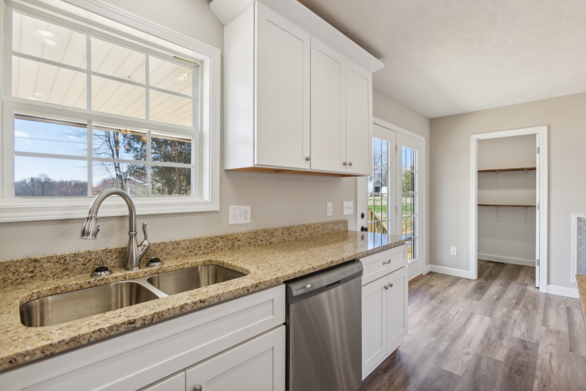 812 Days Road Lafayette, TN 37083 - Photo 9 of 25 a kitchen with granite countertop a sink and dishwasher with wooden floor