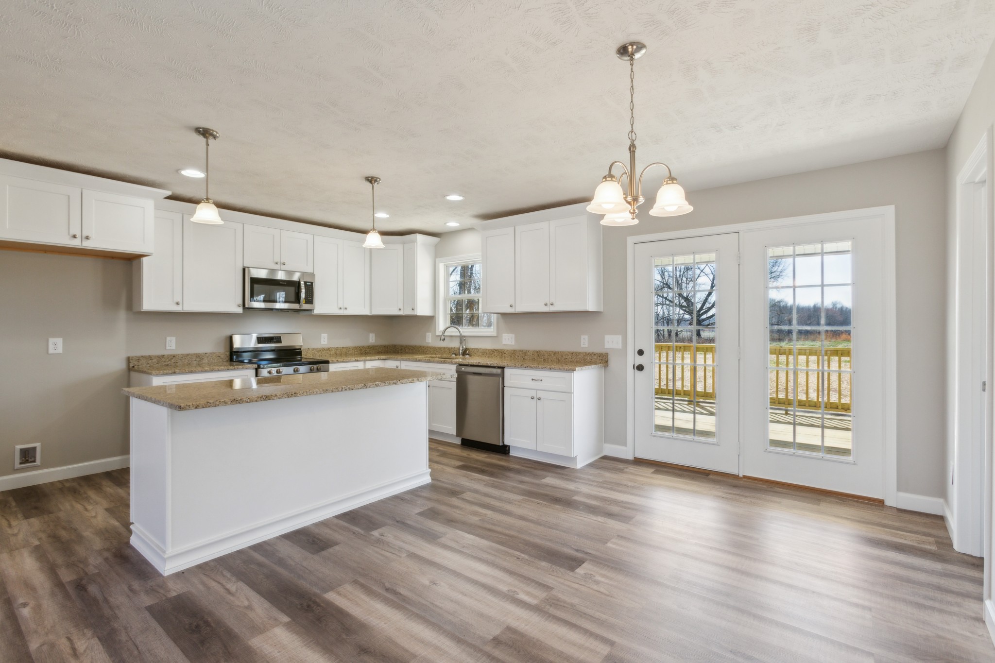 812 Days Road Lafayette, TN 37083 - Photo 10 of 25 a kitchen with wooden floors and white cabinets