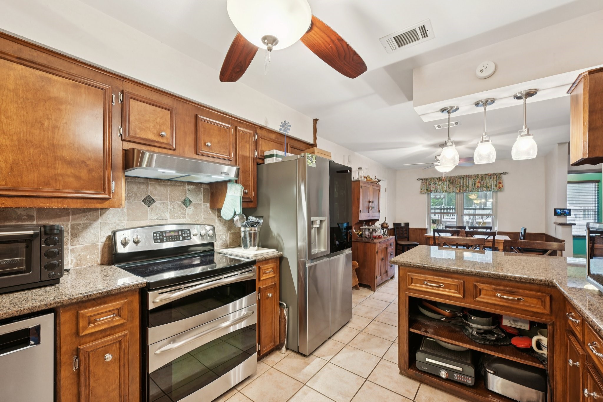 2007 Diane Street Pinehurst, TX 77362 - Photo 12 of 49 a kitchen with a stove and a refrigerator