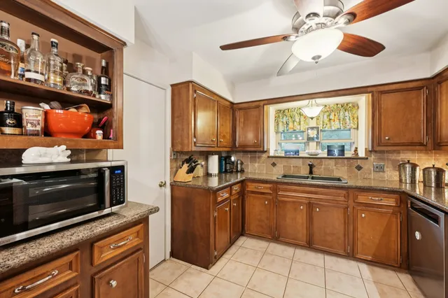 a kitchen with stainless steel appliances a stove sink and microwave
