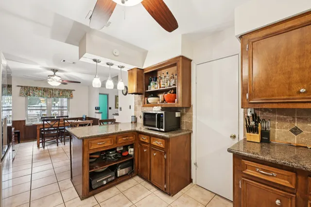 a kitchen with stainless steel appliances granite countertop a stove and cabinets