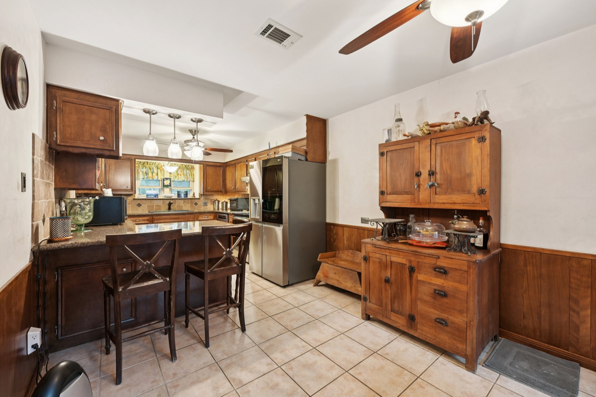 2007 Diane Street Pinehurst, TX 77362 - Photo 16 of 49 a kitchen with stainless steel appliances kitchen island granite countertop a table and chairs in it