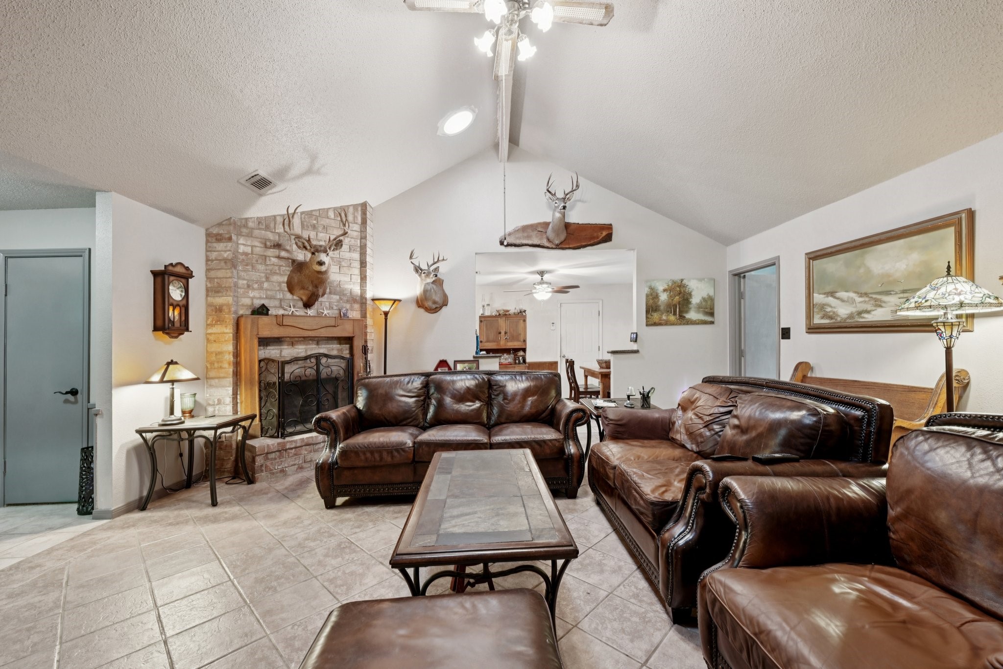 2007 Diane Street Pinehurst, TX 77362 - Photo 20 of 41 a living room with furniture a fireplace and a chandelier
