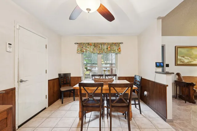a view of a dining room with furniture and a window