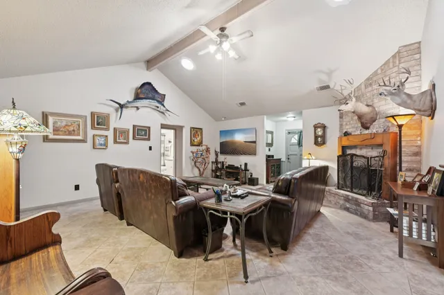a living room with furniture kitchen view and a large window