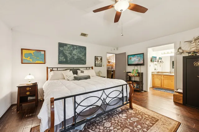 a bed room with a bed a dresser and a television