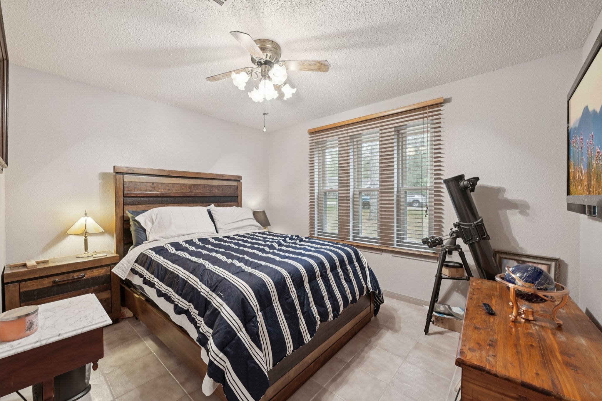 2007 Diane Street Pinehurst, TX 77362 - Photo 32 of 49 a bedroom with a bed and a chandelier