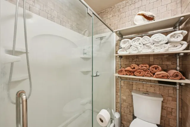 a view of a bathroom with a shower and a sink