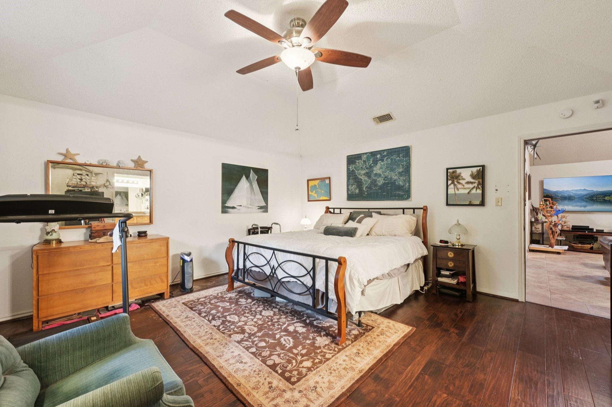 2007 Diane Street Pinehurst, TX 77362 - Photo 36 of 49 a spacious bedroom with a bed a dresser and wooden floor