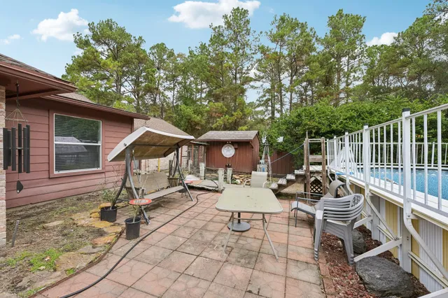 a view of a chairs and table in backyard of the house