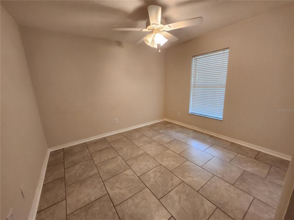6521 East Grayson Street Inverness, FL 34452 - Photo 13 of 16 an empty room with windows and fan