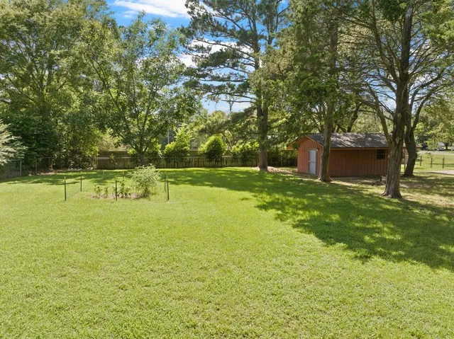 a swimming pool with outdoor seating and yard