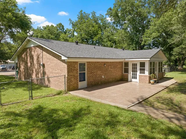 a kitchen with stainless steel appliances granite countertop a kitchen island a stove a table and chairs