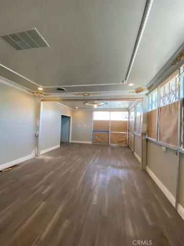 a view of a room with wooden floor