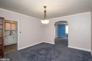 1618 Roundhill Road Baltimore, MD 21218 - Photo 11 of 50 a view of a hallway with windows and chandelier