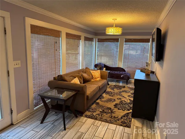 a view of a hallway with wooden floor and a fireplace