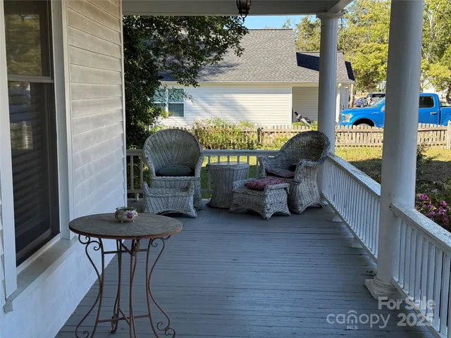 a view of a two chairs in the balcony