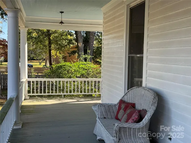 a living room with furniture a fireplace and a chandelier