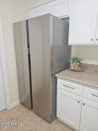 a kitchen with metallic refrigerator freezer and a dishwasher