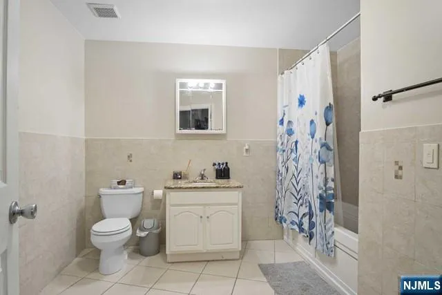 a bathroom with a toilet sink and shower