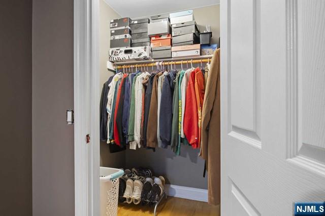 15-19 Tichenor Lane, Unit 404 Newark, NJ 07114 - Photo 14 of 22 a view of walk in closet with clothes and shoes